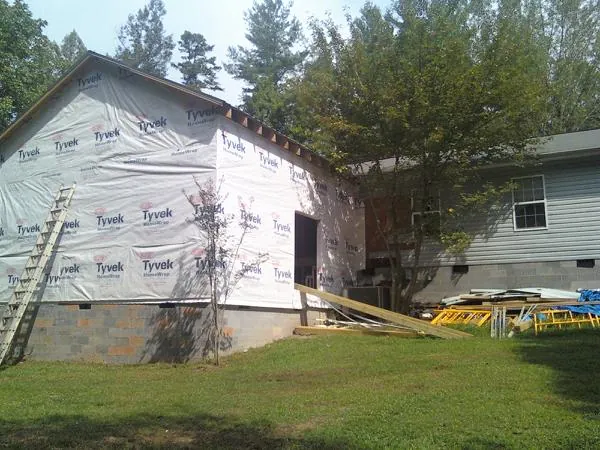 Tyvek wrapped gable on a new room addition beside an existing home in Mount Pleasant